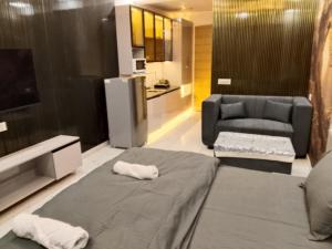 a living room with a bed and a couch at Kremlin Luxury Studios in Ghaziabad
