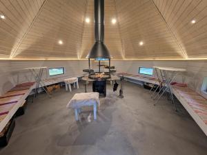 an empty room with tables and chairs in a building at Matkailumaja Heikkala Cottages in Ruka
