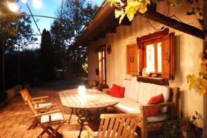 a patio with a table and chairs and a window at Kuća za odmor Grunt in Veliko Trgovišće