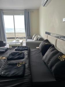 a living room with two beds and a couch at voya hotel and suites in Soûr +2 photos