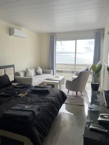 a bedroom with a bed and a living room at voya hotel and suites in Soûr