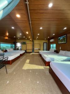 a large room with four beds in it at Lona Villa Tam Coc in Vũ Lâm +81 photos