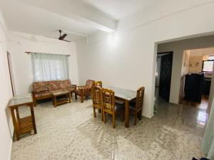 a living room with a dining room table and chairs at HoneyBee 2BHK Homestay Agonda in Agonda