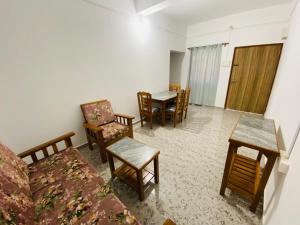 a living room with a couch and chairs and a table at HoneyBee 2BHK Homestay Agonda in Agonda