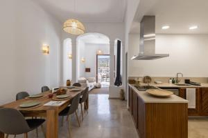 a kitchen and dining room with a table and chairs at Ca Sa Joia - Beautiful Views in Port d'Andratx