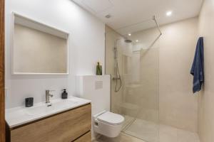 a bathroom with a toilet and a sink and a shower at Ca Sa Joia - Beautiful Views in Port d'Andratx +12 photos