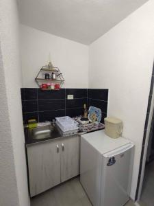 a small kitchen with a sink and a refrigerator at Villa DIJA in Kruševo +3 photos