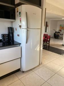 a white refrigerator in a kitchen with a table at Piso Céntrico Maipú in Maipú +15 photos