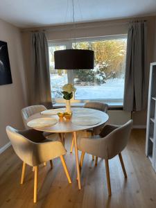 a dining room with a table and chairs and a window at Kutscherhaus in Uelzen +12 photos