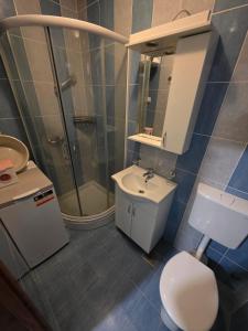 a bathroom with a toilet and a sink and a shower at Villa Nela in Tivat +24 photos