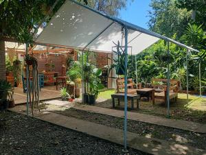 a tent in a garden with a bench and a table at Kactus de la abuela in Yerba Buena