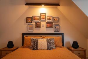 a bedroom with a bed with pictures on the wall at Sea Crest - Beachfront Escape with Whisky Snug in Cullen