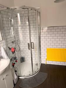 a shower in a bathroom with a yellow bench at Titanic Shadow - 5 mins from Belfast City Centre in Belfast +32 photos
