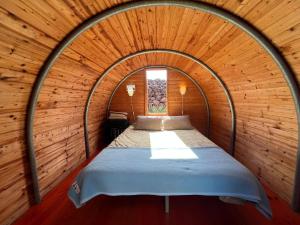 a bedroom with a bed in a wooden room at The Secret Garden Lanzarote in Haría