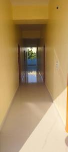 an empty room with a hallway with two doors at Rk comforts & lodge in Madhugiri
