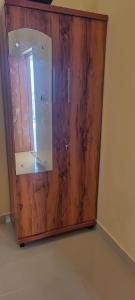 a wooden door with a mirror in a room at Rk comforts & lodge in Madhugiri