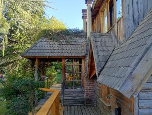 a house with a porch and a door on it at Casa Patagónica con Vista al Lago y Jardín Ideal Familias en Bariloche in San Carlos de Bariloche