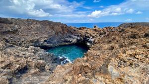 a hole in the rocks near the ocean at The Secret Garden Lanzarote in Haría