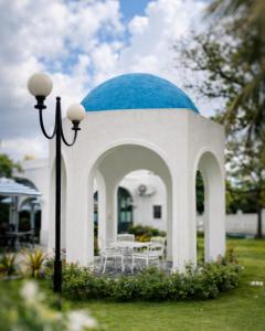 a white building with a blue dome on top of it at Rizz Santorini Apartment in Negombo