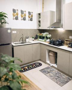 a kitchen with a sink and a stove at Rizz Santorini Apartment in Negombo
