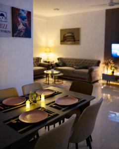 a living room with a table with chairs and a couch at Rizz Santorini Apartment in Negombo +52 photos
