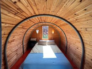 a bed in a room with a wooden ceiling at The Secret Garden Lanzarote in Haría +18 photos