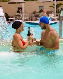 a man and a woman in the swimming pool at Vesuvio Inn Bed & Wine Experience in Boscotrecase +197 photos