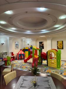 a childrens play area with a play room with a playground at Hotel Rigga in Władysławowo