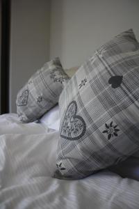 a bed with two pillows on top of it at Il giardino in campagna in Seren del Grappa