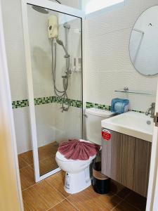 a bathroom with a shower and a toilet and a sink at Koh Yao Modern Inn -SHA Plus in Ko Yao Yai +61 photos