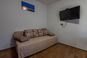 a living room with a couch and a flat screen tv at David in Mali Lošinj