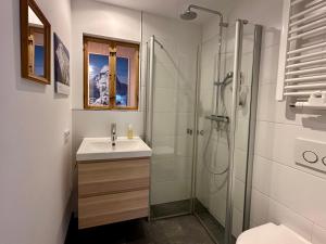 a white bathroom with a sink and a shower at Ein Haus am Berg in Marquartstein +19 photos