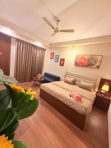 a bedroom with a bed and a ceiling fan at Hazelnut -Expo India centre in Greater Noida