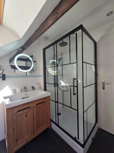 a bathroom with a sink and a glass shower at Les Ruisseaux in Cauterets +44 photos
