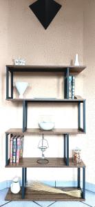 a wooden shelf with books and a plate on it at Logis Hôtel Restaurant Le Palous in Baraqueville