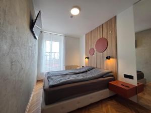 a bedroom with a large bed and a window at Apartman Nika in Pirot