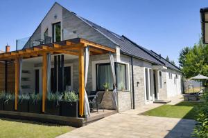 a house extension with a deck and patio at Brothers House in Balatonszárszó