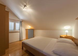 a bedroom with a large white bed and a window at Captain's Villa Sokol in Lumbarda +45 photos