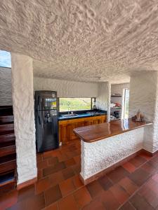 a kitchen with a counter and a refrigerator at Finca Lituania, El Sisga in Chocontá