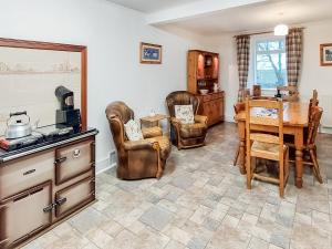 a kitchen with leather furniture and a table and chairs at Culquhasen in Gillespie +20 photos