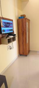 a room with a computer and a cabinet at Rk comforts & lodge in Madhugiri
