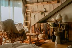 a room with a staircase and a chair and a table at Impression Nordic Manor Club in Ren'ai