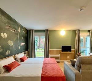 a bedroom with a large bed and a couch at Luxury Singular Apartments Padrón in Padrón