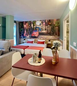 a living room with two beds and a table at Luxury Singular Apartments Padrón in Padrón