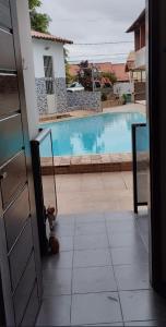 a view of a swimming pool from a door at Suíte da Lagoa in Araruama