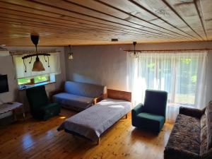 a living room with a couch and two chairs at Paide Homestay in Kriilevälja
