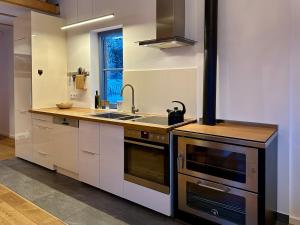 a kitchen with a sink and a stove at Ein Haus am Berg in Marquartstein