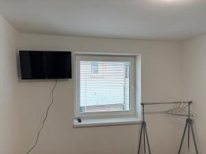 a room with a window and a flat screen tv at Apartman pri kostole in Krásno nad Kysucou