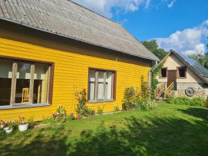 a yellow house with a yard at Paide Homestay in Kriilevälja