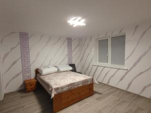a bedroom with a bed and a window at Ferienwohnung Clausthal in Clausthal-Zellerfeld